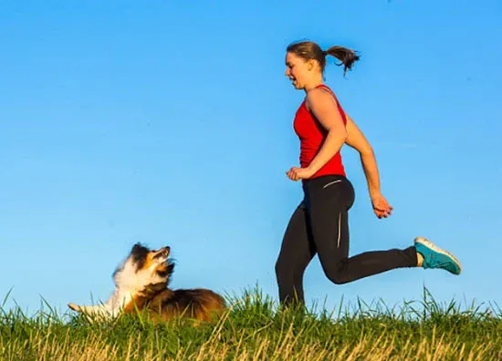 girl running with dog